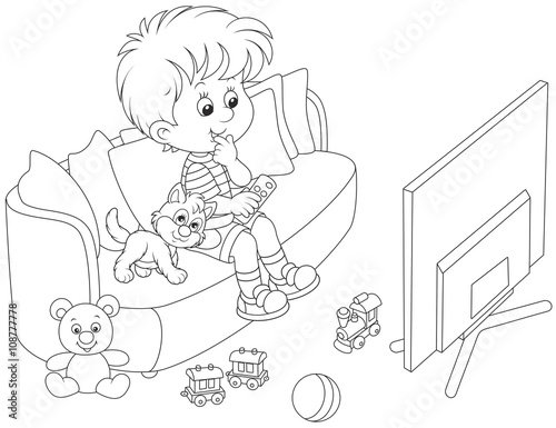 little boy sitting on the sofa and watching TV
