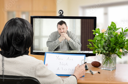 Depressed man in monitor of psychotherapist 
