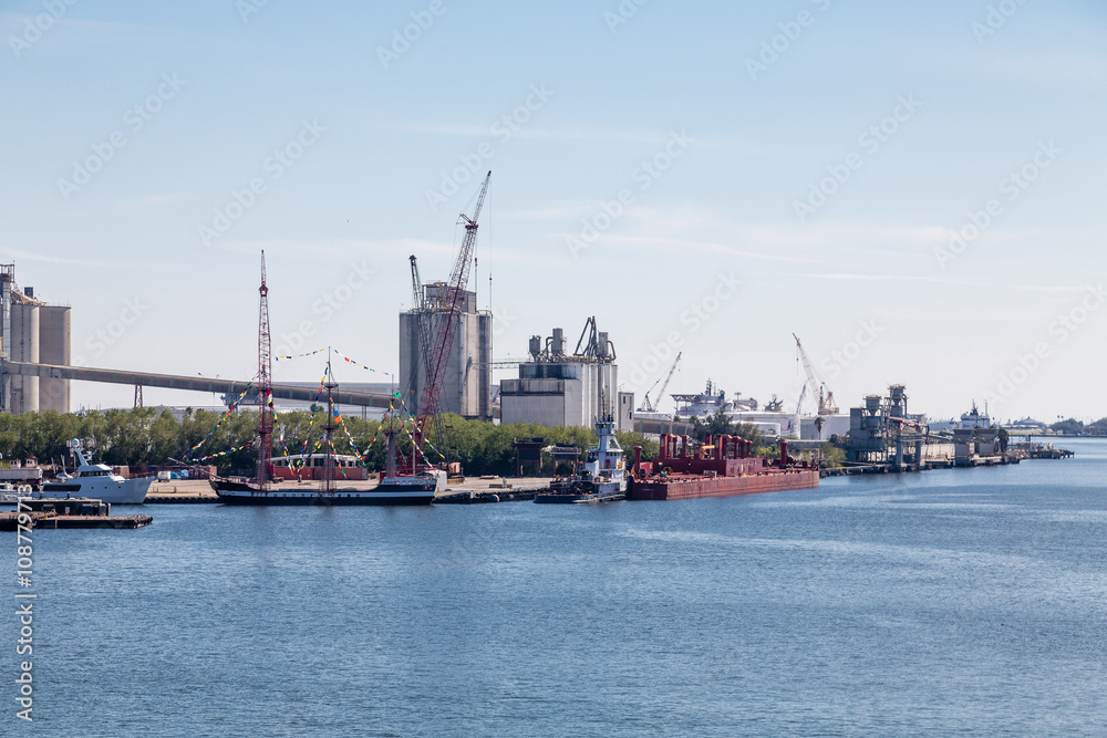 Sailboats and Industrial Ships in Harbor