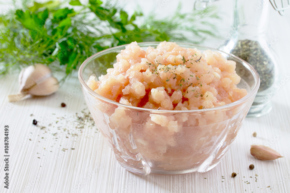 Healthy food background, raw minced meat in a bowl and various s Healthy food background, raw minced meat in a bowl and various s