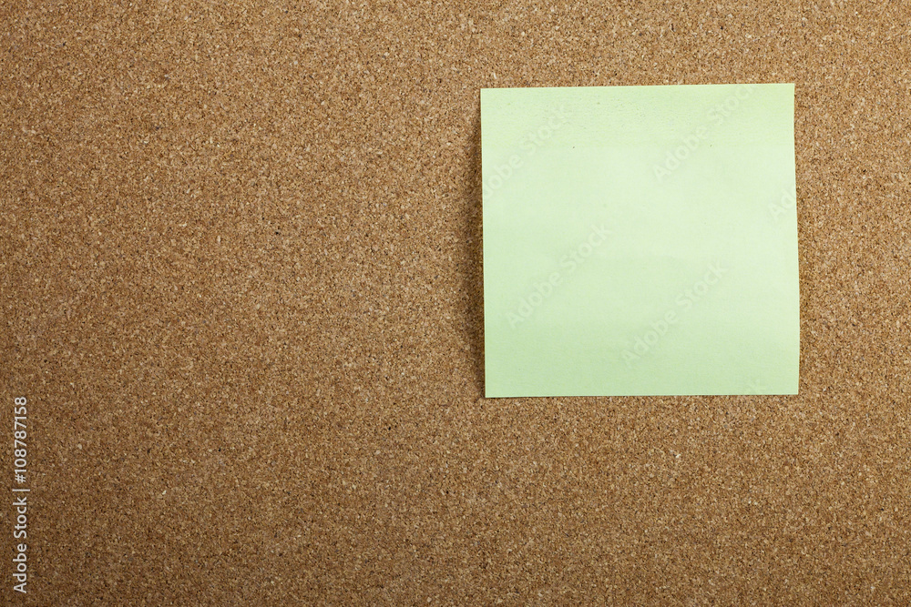 Yellow sticky note on cork board