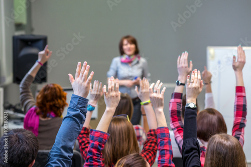 Fototapeta Naklejka Na Ścianę i Meble -  Active Students raising Arms up ready to answer Teachers Question