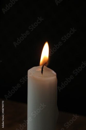 Candle lit on a restaurant table
