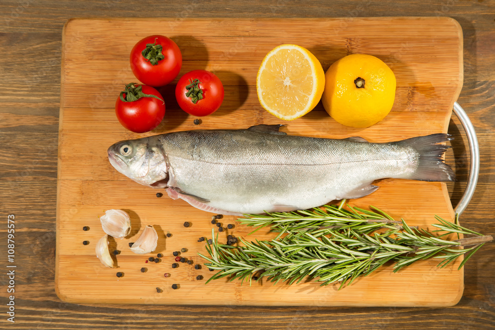 raw trout on rustic wooden table raw trout on rustic wooden table