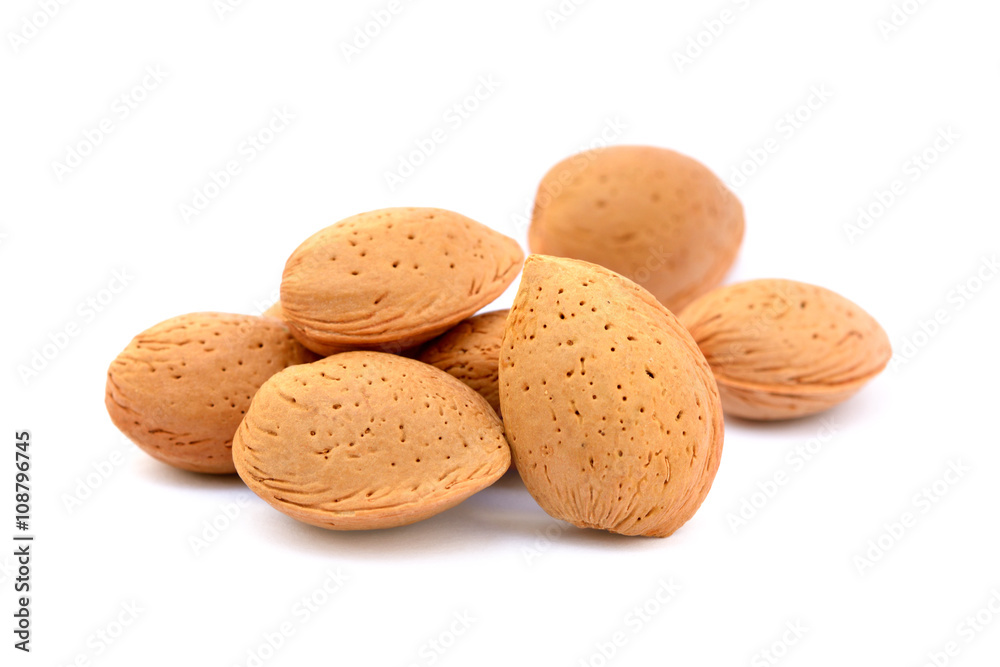 Pile of unpeeled almonds isolated on white background Pile of unpeeled almonds isolated on white background