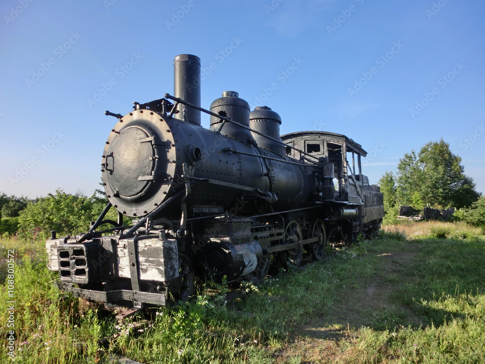 Vintage old antique train locomotive engine perspective in sun - landscape color photo