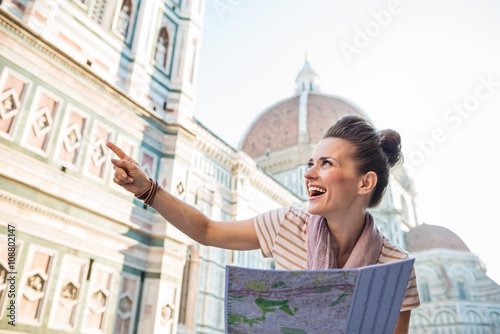 Happy woman tourist with map pointing on something, Florence © Alliance