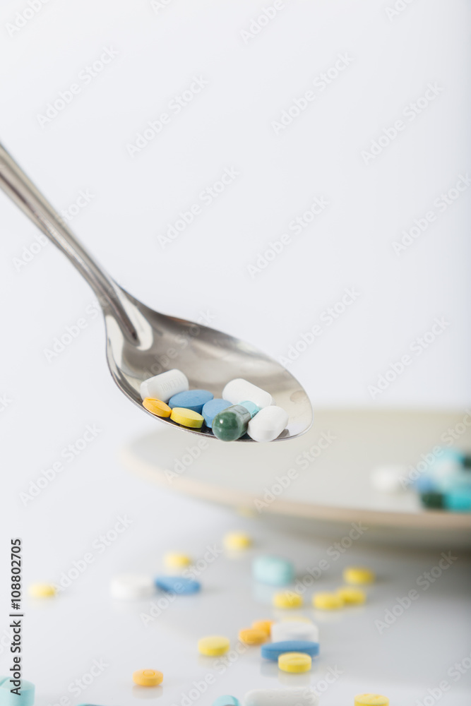 Pills on a spoon (selective focus) Pills on a spoon (selective focus)