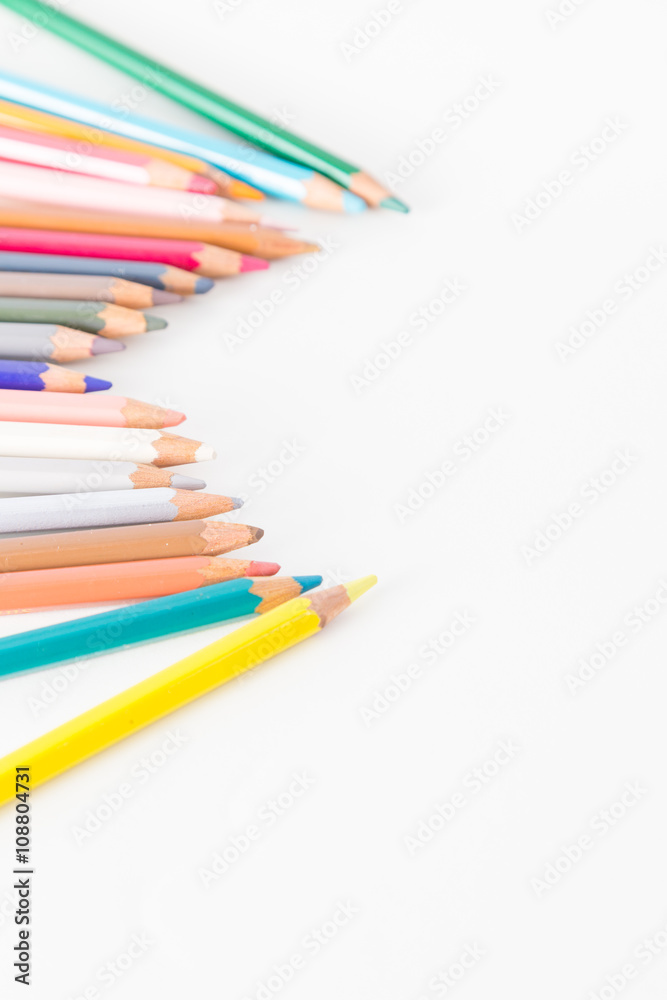 Closeup of Colour pencils on white background, selective focus Closeup of Colour pencils on white background, selective focus