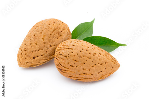 Almonds with leaves isolated on white background