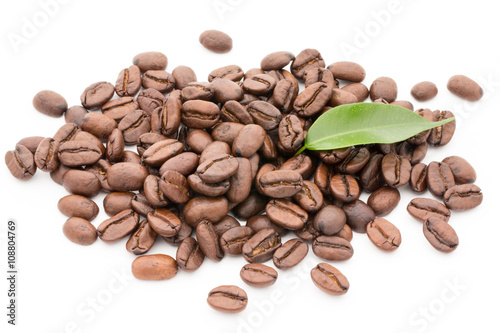 Coffee grains and leaves isolated on the white backgrounds.