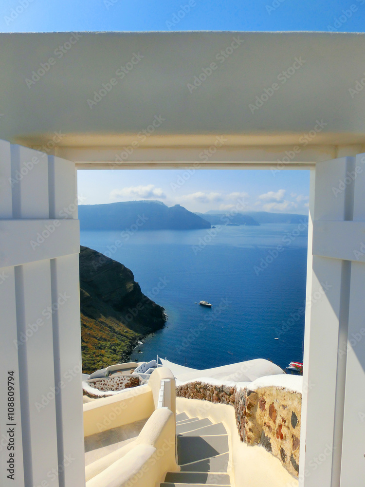 Fototapeta Beautiful sea view from the open gate. Santorini island, Greece.
