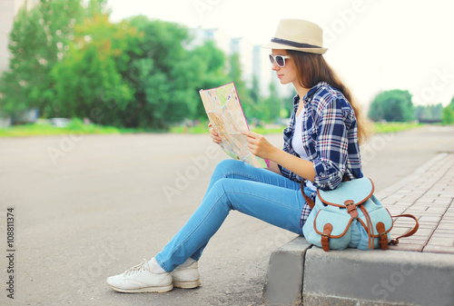 Young woman tourist sightseeing city with paper map
