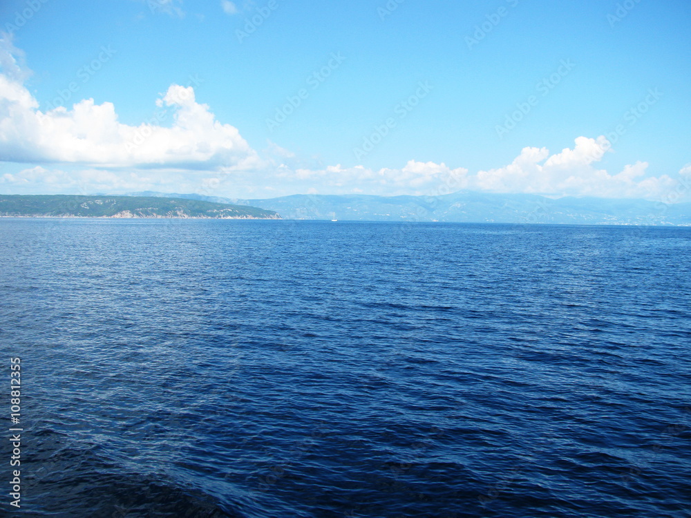 blue sea on background of island