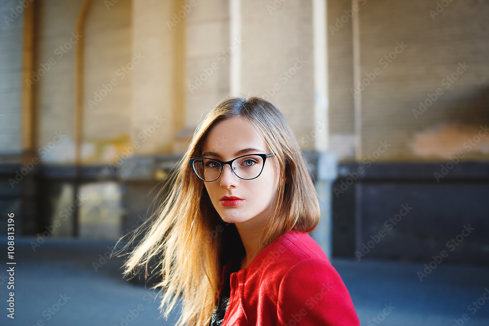 beautiful young blond girl with glasses in the street. beautiful young blond girl with glasses in the street.