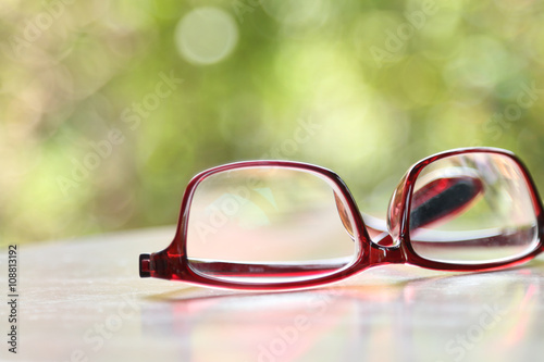 hipster glasses on wooden table with nature background