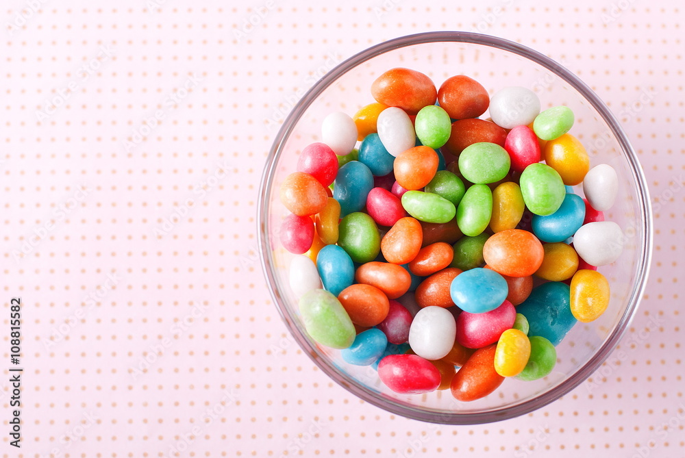 colorful candies in a bowl on a table colorful candies in a bowl on a table