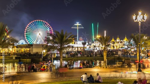 Main square and lake in Global Village with crowd and attractions timelapse in Dubai, UAE