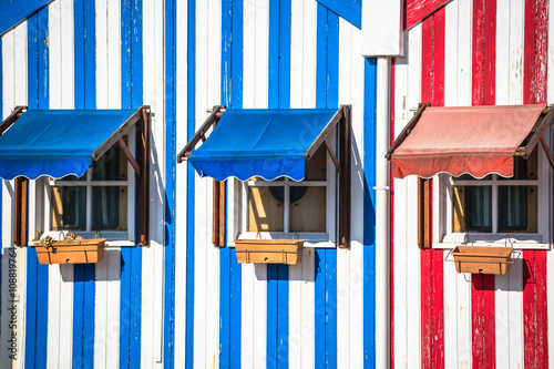 Colorful striped fishermen's houses in blue and red, Costa Nova,