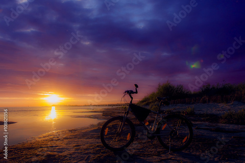 Stationary bike at sunset sky beautifully.