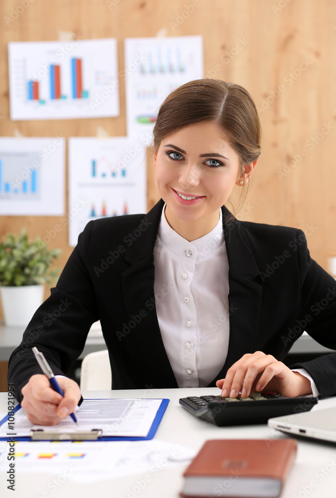 Beautiful businesswoman sit at workplace in office work with pap