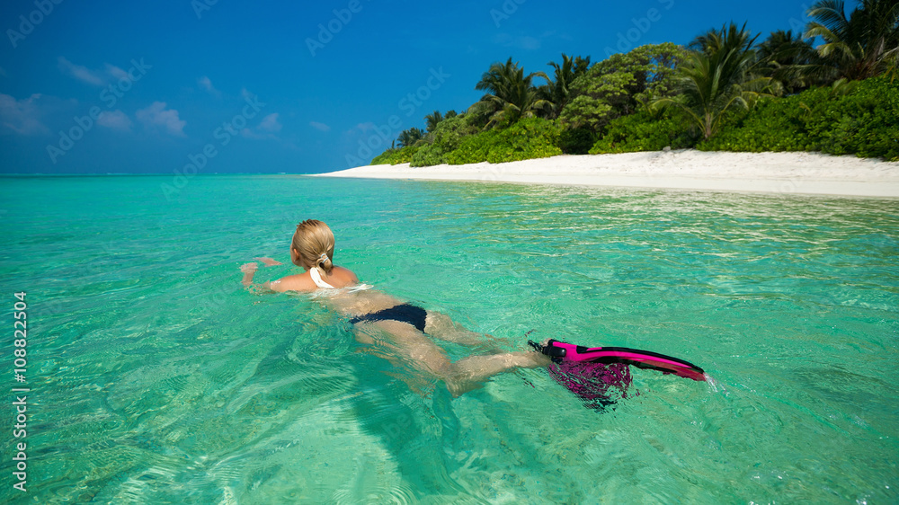 Woman holding mask and flippers for swimming Woman holding mask and flippers for swimming