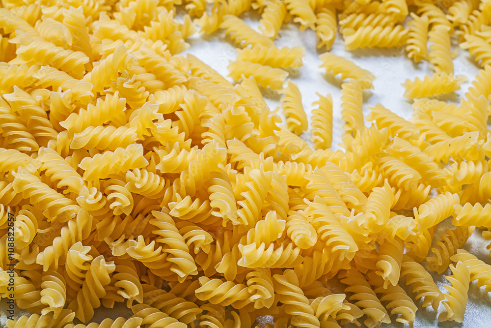 Stack of spiral macaroni on blue background food and drink conce
