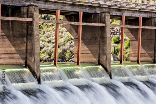 High water spills through gates on a Dam