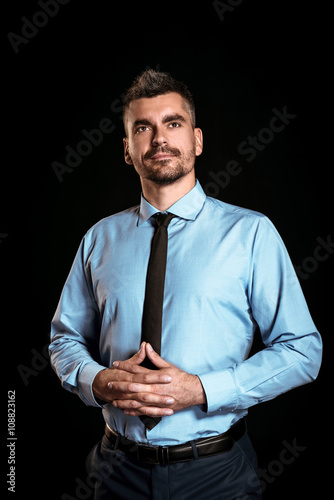 Handsome businessman on black background