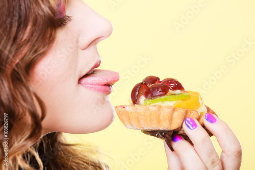 Closeup funny woman eating fruit cake