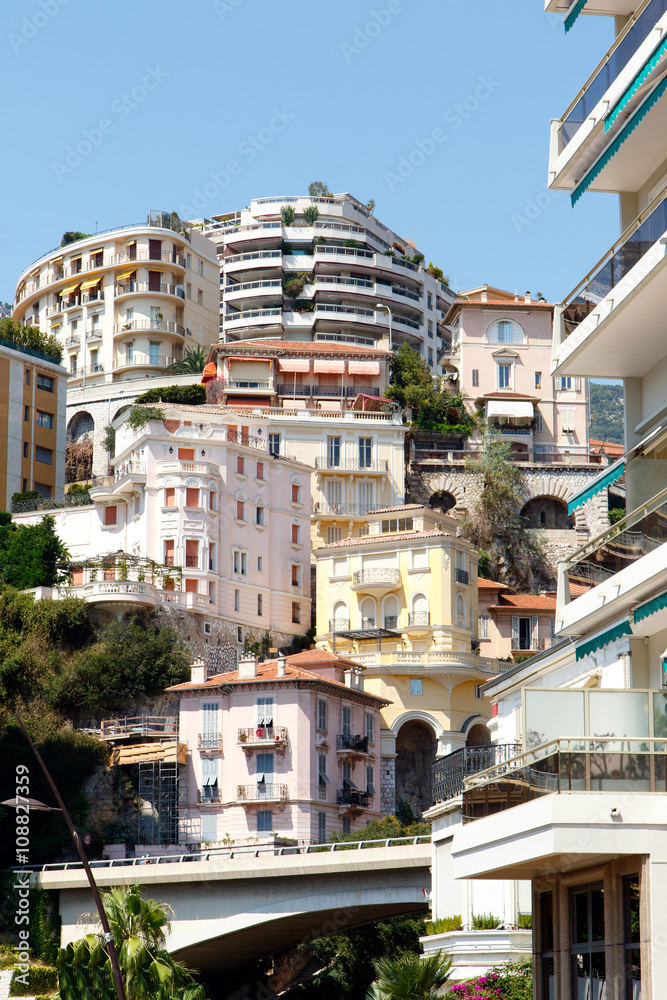 Color DSLR stock image of crowded apartment buildings in Monte Carlo in Monaco on the French Riviera, with a clear blue sky background. Horizontal with copy space for text