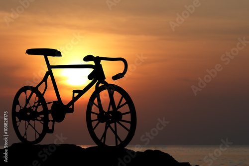 Silhouette of a bike at orange sunset