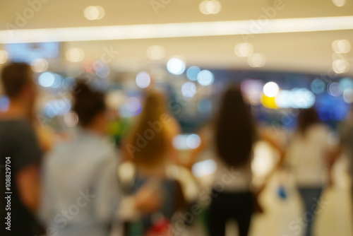 People shopping in mall. Defocused blur bokeh background.