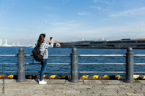 Woman take photo in Yokohama harbor