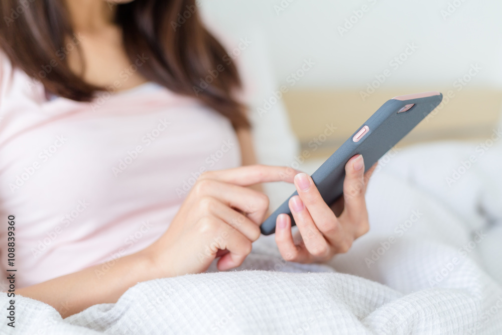 Woman use of cellphone on bed Woman use of cellphone on bed