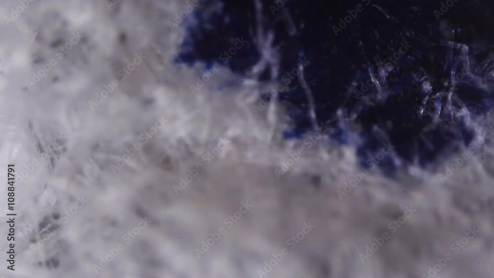 Dripping blue Ink on Paper. The paper absorbs blue Ink paint. Micro shot.. Dripping blue Ink on Paper. The paper absorbs blue Ink paint. Micro shot..