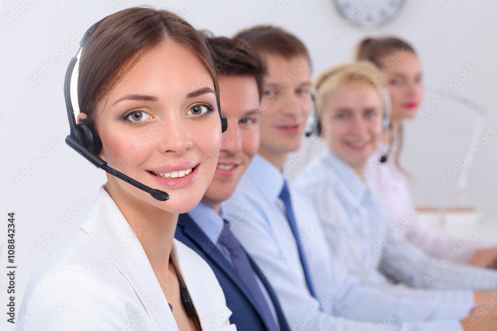 Attractive Smiling positive young businesspeople and colleagues in a call center office Attractive Smiling positive young businesspeople and colleagues in a call center office