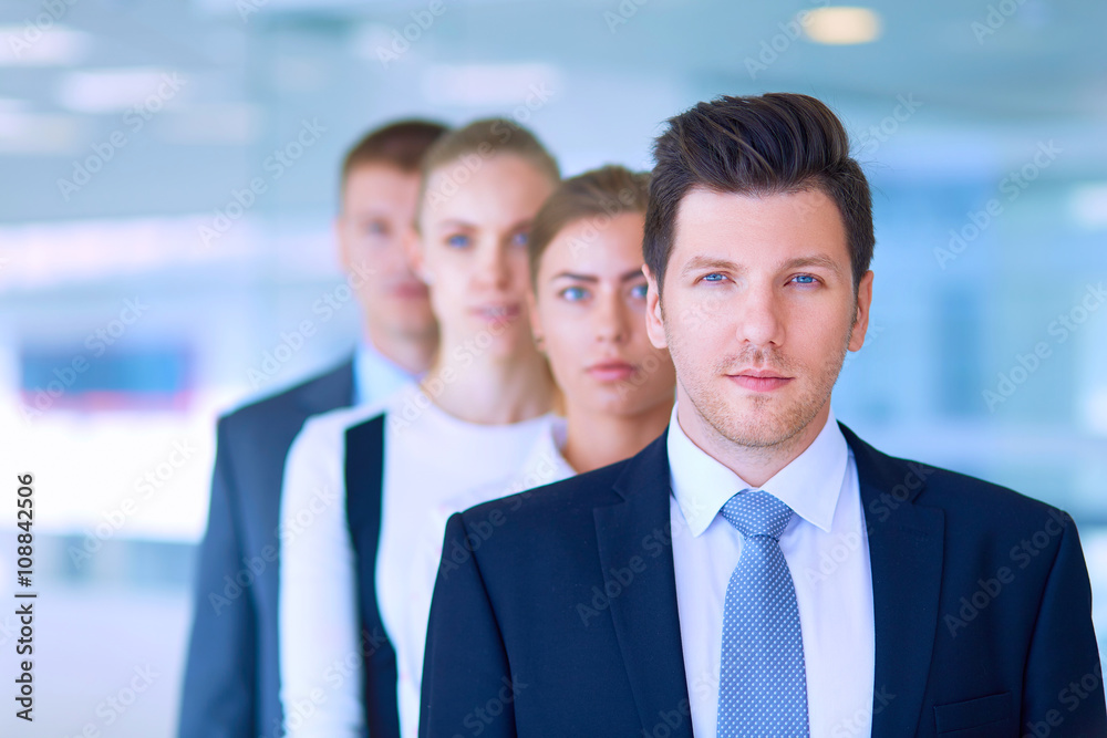 Smiling successful business team standing in office Smiling successful business team standing in office