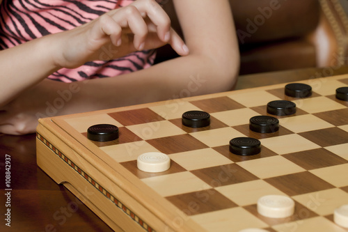 young girl playing checkers