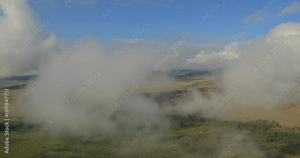 Flying through clouds with beautiful landscape view over the mountains. Flying through clouds with beautiful landscape view over the mountains.