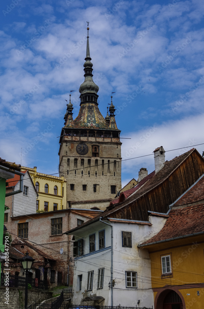 Obraz premium Clock tower and old houses of medieval town of Sighisoara, Transylvania, Romania