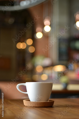 cup of espresso coffee with blur cafe shop background