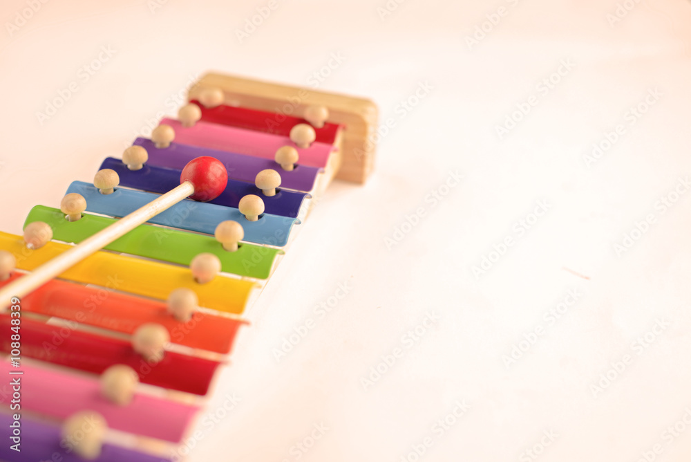 Fototapeta premium Colorful baby xylophone with stick isolated over white backgroun