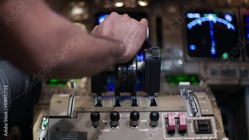 Detail shot of airline pilot's hand pushing forward on 747 jet throttle.  Rear view, originally recorded in 4K.