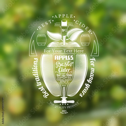 Engraving style apple with glass and corkscrew for text in the center. Silhouette Cider label in the centre of blurred photo of apple harvest