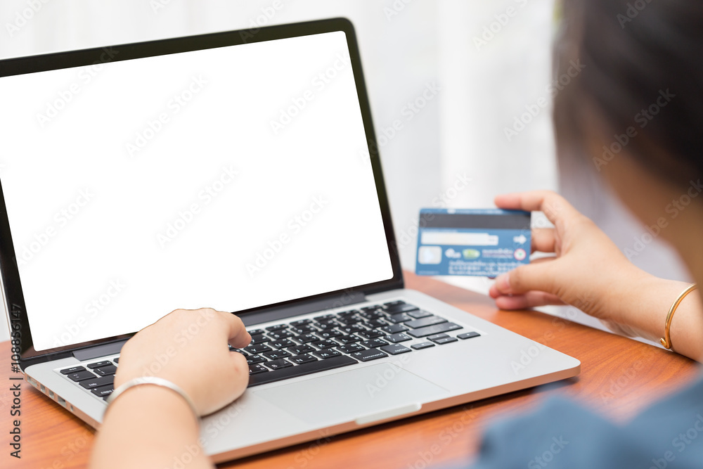 Hand on computer notebook fill credit card data with copy space. Hand on computer notebook fill credit card data with copy space.