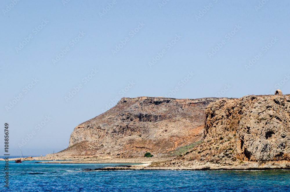 Old pirate fortress on the island Gramvousa on the background of the Mediterranean sea and blue sky.