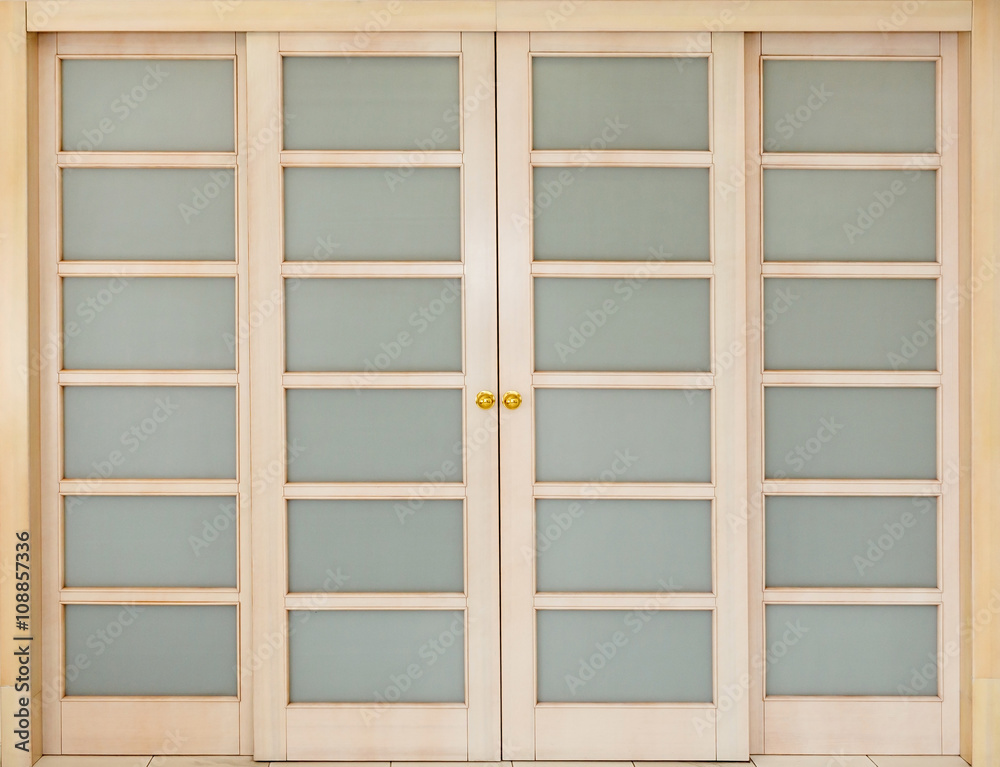 Obraz premium wooden sliding door with glass inserts.