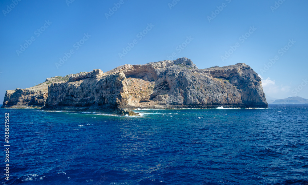 The rocky coast of the Mediterranean sea against the blue sky on a clear summer day
