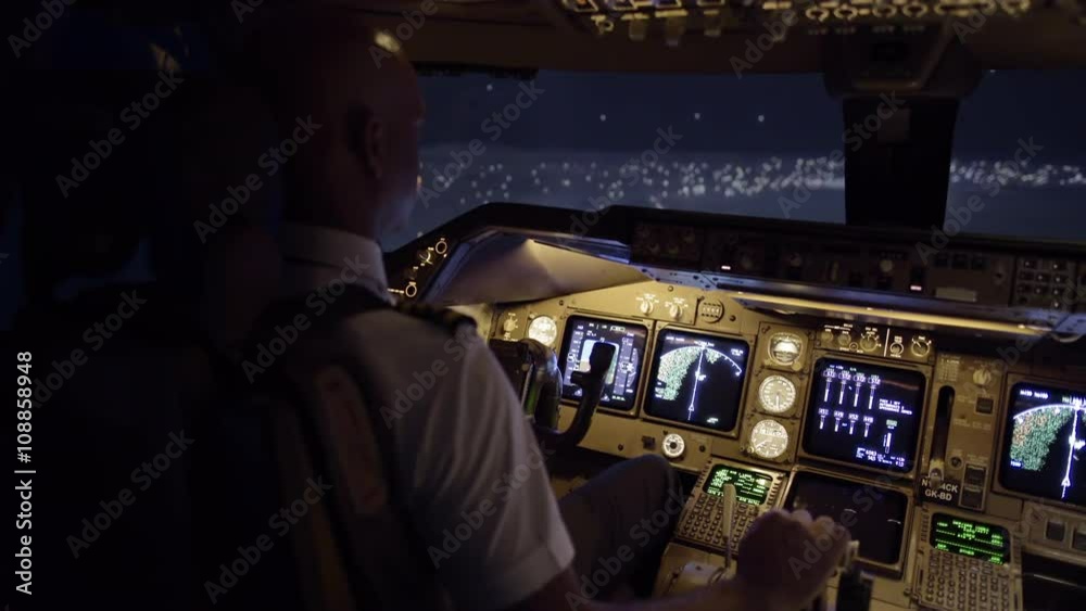 Cockpit view as pilot flies a jumbo jet over northern California, USA, at night.  Stabilized hand-held camera, originally recorded in 4K at 30ps.